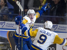 Saskatoon Blades forward Chase Wouters celebrates the overtime-winning goal with forward Max Gerlach against the Moose Jaw Warriors in Game 1 of their first-round WHL playoff series at SaskTel Centre.