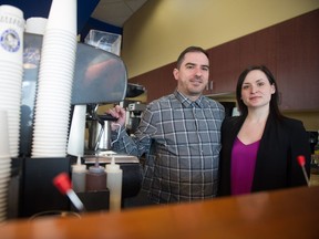 Tim Martin, left, and Abbey Martin, owners of Atlantis Coffee on Victoria Avenue, stand behind the bar next to the cafe's espresso machine. At the end of March, Atlantis will shut down to make way for a new coffee shop.