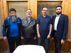 From left, Aas Malik, Ashref Darbi, Hocine Krazini and Adnan Cheema stand in an office building on Broad Street. All are members of a committee with the Islamic Society of Regina, which is fundraising to build a new non-profit, Muslim-only cemetery near Regina.