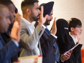 New Canadians take the oath of Canadian citizenship during a ceremony held at the SIAST Regina campus on March 22, 2019. BRANDON HARDER/ Regina Leader-Post