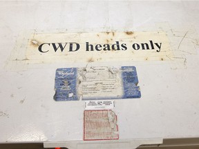 A sign on a freezer indicating it was being used for the storage of deer heads suspected of Chronic Wasting Disease, seen during a tour with Saskatchewan Conservation Officer Kerry Wrishko, inside the SERM office Friday, Nov. 1, 2013.