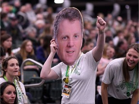 A University of Regina Cougars fan holds a large-head version of head coach Dave Taylor at the 2018 U Sports women's basketball tournament, held at the Centre for Kinesiology, Health and Sport.