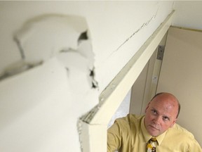 Shawn Pearce, former principal of École St. Pius X, looks up at cracks in the walls of an elementary school classroom in April 2017.