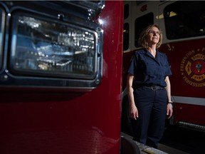Lieutenant Marianne Boychuk of the Regina Fire Department stands between trucks at Fire Hall #4 on Dewdney Avenue. Boychuk was Regina's first female firefighter and has now become the first woman in a leadership role.