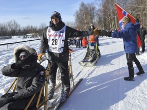 Defending champion Joar Leifseth Ulsom is greeted by local fan Ole Andersson during the ceremonial start of the Iditarod Trail Sled Dog Race Saturday, March 2, 2019 in Anchorage, Alaska.