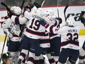 Members of the host Regina Pats celebrate a win over the WHL-champion Swift Current Broncos  during the 100th Memorial Cup at the Brandt Centre in Regina.