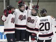 The Regina Pat Canadians' Noah Kuntz, second from left, celebrates a goal against the Saskatoon Contacts in Saskatchewan Midget AAA Hockey League playoff action Friday at the Co-operators Centre.