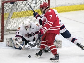 Regina Pat Canadians goalie Jared Thompson dives for the loose puck against the Notre Dame Hounds in Saskatchewan Midget AAA Hockey League playoff action Tuesday at the Co-operators Centre. Thompson got the shutout as Regina won 2-0.