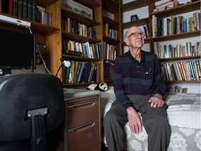 Adrian Paton, who compiled his collection of photographs depicting Indigenous people into a book called An Honest, Genial and Kindly People, sits in the bedroom of his home in Arcola, Sask. Despite having ample room in his home, Paton prefers to sleep on a small bed in this small room. Surrounded by books, he jokes that when he can't sleep at least he can find something to read.