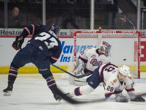 Regina Pats goaltender Max Paddock watches a shot by his former teammate Nick Henry (23), now of the Lethbridge Hurricanes, sails past him during WHL action at the Brandt Centre.