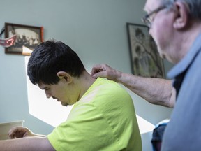 Josh Wanner spends time in his room with his grandfather Rick, right, in Weyburn, Sask. on Thursday, March 14, 2019. Josh, who has autism, was to have a spot in a group home for people with mental and physical disabilities in a new neighbourhood called The Creeks, but Weyburn's city council voted down the proposal on Monday citing safety concerns and damage to property values.