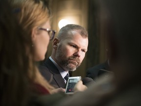 Dustin Duncan, minister of environment and minister responsible for SaskPower, speaks with reporters in the Legislative Building on March 4, 2019.