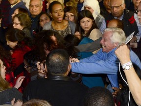 A man clashes with Vanessa Gray who disrupted a speech by Prime Minister Justin Trudeau at a Liberal Climate Action Rally in Toronto, Monday, March 4, 2019.