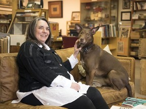 Leah Spafford, owner of Spafford Books, inside her store located in downtown Regina.  She took it over from her father 14 years ago when he suffered a stroke.  Her dog Oxford is also a attraction at the store.