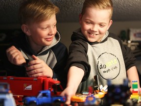 Eleven-year-old Nate Starycki, right, lives with intestinal failure. He is currently on a donor list, but the situation is dire. Nate and his brother, Deagen play with his collection of Lego on their farm near Maymont, Sask.