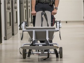 SASKATOON,SK--APRIL 17/2019-*0416 NEWS Restraint Chair - Special Constable Brandon Roberts pushes a restraint chair at the Saskatoon Police Services headquarters in Saskatoon on Wednesday, April 17, 2019.