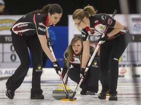 Ontario's skip Rachel Homan, centre, throws as lead Lisa Weagle, left, and second Joanne Courtney prepare to sweep against Sweden's Isabella Wrana's (not pictured) team during the Humpty's Champions Cup at Merlis Belsher Place in Saskatoon on Tuesday, April 23, 2019.