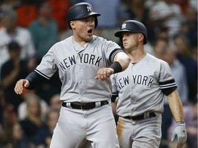Luke Voit #45 of the New York Yankees celebrates with Brett Gardner #11 after both scored on a double off the bat of Gary Sanchez in the sixth inning against the Houston Astros at Minute Maid Park on April 09, 2019 in Houston, Texas.