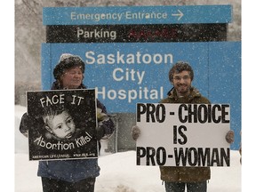 People on opposite sides of the abortion debate walked with placards in front of City Hospital in Saskatoon