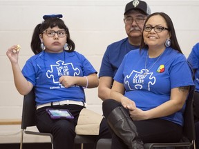 Jeanelle Mandes speaks at Regina's sixth annual "Light It Up Blue" autism awareness day event. Her daughter Sharlize, left, was diagnosed with Autism Spectrum Disorder (ASD) when she was three years old.