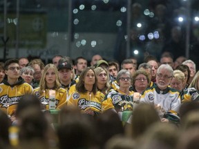 Family members and friends light candles during the Humboldt Broncos memorial service at Elgar Petersen Arena in Humboldt, SK on Saturday, April 6, 2019.