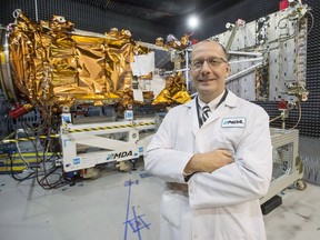 MDA's President Mike Greenley is seen in front of one of three RADARSAT Constellation Mission spacecrafts being built for the Canadian Space Agency at the company's facility in Sainte-Anne-de-Bellevue, Quebec on Tuesday January 30, 2018. With an eye on future lunar exploration, Canada's space agency is calling on companies to present their ideas for everything from moon-rover power systems to innovative mineral prospecting techniques.