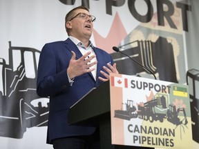 Premier Scott Moe speaks at Evraz Place in Regina during a rally protesting the carbon tax, Bill C-69, Bill C-48, and advocating for pipelines.