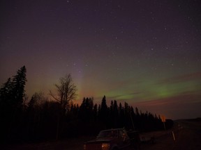 The northern lights shine above the glow from a wildfire on highway 63 south of Fort McMurray, Alta., on May 6, 2016. New online maps lets viewers zero in on how climate change will affect the part of Canada's boreal forest where they live. The maps are part of an ongoing effort at the University of Winnipeg to help Canadians understand how global warming will change their own part of the country.