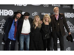 Inductee Stevie Nicks, center, poses with other members of Fleetwood Mac, from left, Mike Campbell, John McVie, Christine McVie and Mick Fleetwood at the Rock & Roll Hall of Fame induction ceremony in New York on March 29, 2019. Fleetwood Mac is postpoing four Canadian tour dates as Stevie Nicks deals with the flu. A statement issued by the band says concerts in Toronto (April 8), Winnipeg (April 11), Edmonton (April 13) and Calgary (May 2) will all be rescheduled, in addition to a number of U.S. dates.