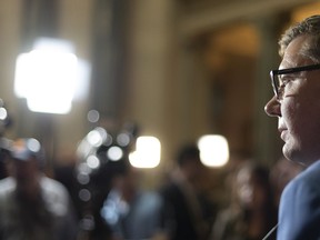 Saskatchewan Premier Scott Moe speaks to media in the rotunda during budget day at Legislative Building in Regina on Wednesday March 20, 2019. Moe plans to speak at a rally Thursday where one of the organizers does not believe climate change poses a threat to the planet.THE CANADIAN PRESS/Michael Bell