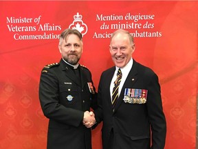 Captain the Reverend Eric Davis poses for a photo with Deputy Minister of Veterans Affairs Walter Natynczyk. Davis was one of 13 Canadians to receive the award on March 29.
