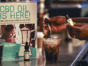 FILE - In this Friday, Jan. 4, 2018 file photo, a worker adds CBD oil to a drink at a coffee shot in Fort Lauderdale, Fla. Cannabidiol is one of more than 100 compounds found in marijuana.