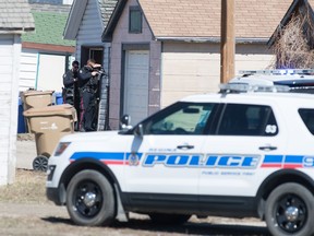 Regina police officers cover the rear of a scene during a police callout after a gunshot was reported on the 1600 block of Montreal Street on Saturday.