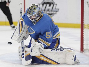 St. Louis Blues goaltender Jordan Binnington (50) makes a stick-save in the first period of an NHL hockey game against the Tampa Bay Lightning in St. Louis on March 23, 2019. St. Louis Blues rookie goalie Jordan Binnington says he has grown up since teenage tweets about women in burkas and cab drivers who speak different languages. The tweets, from 2013 and 2014, were dug up by California-based reporter Paul Gackle. The Winnipeg Free Press reported on the tweets in a story on Tuesday night.