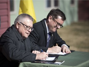 Ralph Goodale, left, federal Minister of Public Safety and Emergency Preparedness, and Paul Merriman, Social Services Minister and Minister Responsible for Saskatchewan Housing Corporation, sign a 10-year housing agreement at the Souls Harbour Mission home on the 1600 block of Angus Street on April 18, 2019.