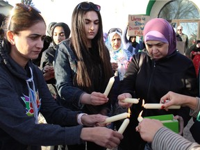 Women light candles at a vigil for the victims of the 50 people murdered in two New Zealand mosques. The vigil was held at the outside the Markaz Ul Islam Mosque in downtown Fort McMurray, on Sunday, March 17, 2019. Laura Beamish/Fort McMurray Today/Postmedia Network