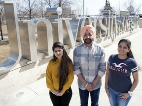Megha Sharma, Bhamandeep Singh and Navneet Kaur, international students from India, stand out front of the large University of Regina sign. Singh is the president of the Indian Students' Association at the U of R. TROY FLEECE / Regina Leader-Post
