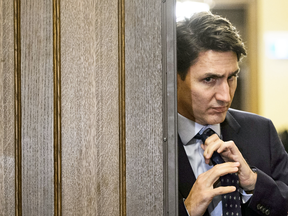 Prime Minister Justin Trudeau adjusts his tie as he leaves a cabinet meeting. No other parliamentary democracy makes unswerving loyalty to the leader a condition of membership in caucus.