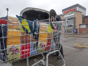 A customer loads her groceries at a Metro store Monday, April 15, 2019 in Ste-Therese, Que, north of Montreal. The grocery chain announced customers will be able to bring their own plastic containers for meat and fish products to cut down on waste.