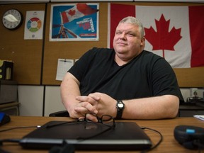 Teacher and head football coach Al Neufeld sits in his classroom at Thom Collegiate in Regina.
