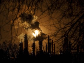 A flare stack lights the sky from the Imperial Oil refinery in Edmonton on December 28, 2018. A new report says direct employment in Canada's oil and gas sector is expected to fall by more than 12,000 jobs this year. PetroLMI says the workforce is expected to drop to about 173,300 in 2019, thus registering a decline of 23 per cent over the past five years from about 226,500 in 2014.