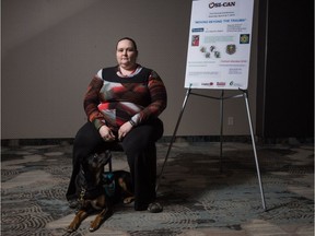 Former 911 dispatcher Cathleen MacPhee sits with her service dog Lyra in the Travelodge Hotel on Albert Street. MacPhee was speaking at an OSI-CAN sponsored conference with a focus on "Moving Beyond the Trauma" in relation to PTSI and Operational Stress Injuries. Her presentation regarded the training of service dogs.