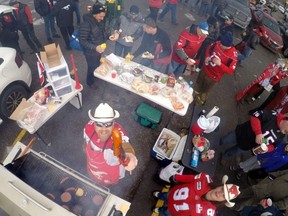 Sheldon Jones offers up a smokie at the CFL Horsemen Tailgate party at the Edmonton Eskimos/Calgary Stampeders CFL 2014 West Final at McMahon Stadium in Calgary, Alberta, on Nov. 23, 2014.