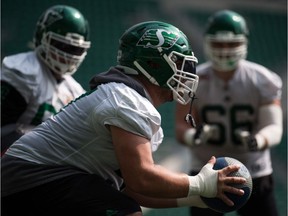 REGINA, SASK : August 17, 2018  -- Saskatchewan Roughriders offensive lineman Dan Clark, centre, performs a twist drill during practice held at Mosaic Stadium. BRANDON HARDER/ Regina Leader-Post