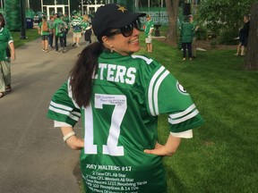 Chryssoula Filippakopoulos models her autographed Joey Walters jersey at Mosaic Stadium in 2018.