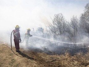 Fire crews use back burning to control a wildfire near Biggar, Sask., on Tuesday, April 23, 2019.