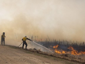 Provincial fire crews attack a brush fire near Biggar, Sask., on Tuesday, April 23, 2019.