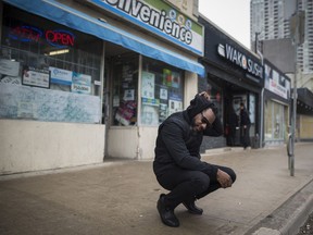 Dion Fitzgerald crouches where he first witnessed the aftermath of the 2018 van attack in Toronto.