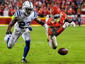 Tyreek Hill of the Kansas City Chiefs dives for the ball in front of Kenny Moore of the Indianapolis Colts at Arrowhead Stadium on January 12, 2019 in Kansas City. (Peter Aiken/Getty Images)