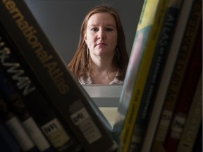 Emily Eaton, a professor in the department of geography and environmental science at the U of R, stands in the map library in the university's classroom building. Eaton is working on a research project  for which she filed a freedom of information request to the university. The university denied her request and she is now appealing the decision.